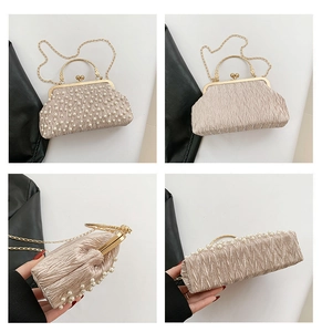 Detail view of champagne pleated evening bag with pearl embellishments and gold metal handle