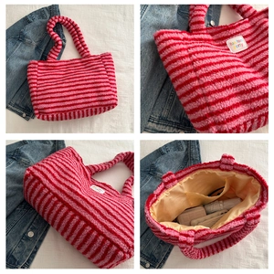 Detail shot of striped plush tote bag interior with large pocket and soft fabric texture