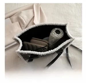 Internal view showing large storage capacity for umbrella and wallet in plush tote bag
