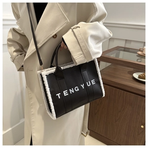 Detailed shot of leather tote bag with white fleece trim and TENGYUE branding