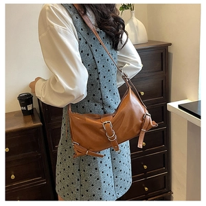 Brown matte PU leather crossbody bag featuring silver metal buckles and decorative long straps
