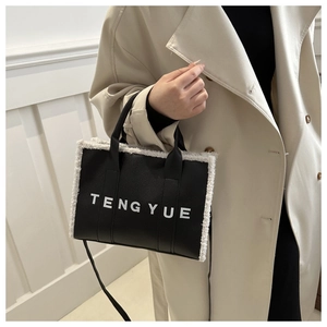 TENG YUE black faux fur trim leather tote bag shown with beige long coat lifestyle view