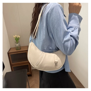 Chic beige crescent shoulder bag in glossy patent leather with adjustable strap for women