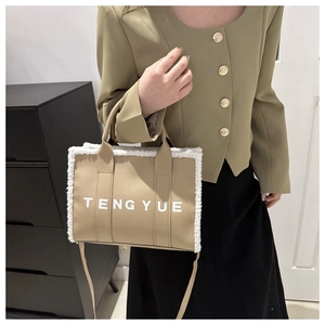 Detail of light brown tote bag with white plush trim and adjustable shoulder strap
