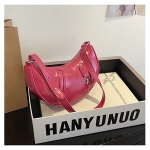 Detail of rose pink crescent underarm bag with leather texture and brand gift box