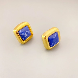 Minimalist square earrings featuring blue turquoise stones in a polished gold metal frame