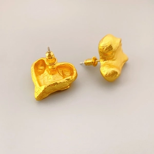 Golden heart-shaped stud earrings with vintage molten texture and matte finish