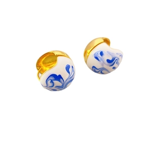 Golden hoop earrings with white enamel and blue marble texture in porcelain style