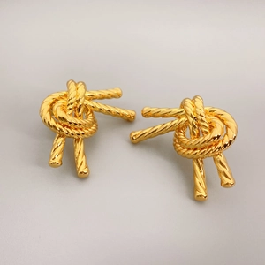Golden knot earrings with twisted rope texture and polished metallic finish
