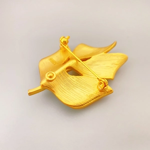 Matte gold leaf brooch back view with metal texture and rotary safety pin clasp
