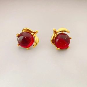 Elegant gold cherry leaf earrings with translucent red beads for a minimalist stylish look