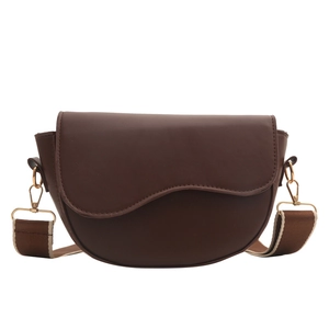 Minimalist dark brown semi-circle saddle bag with striped fabric strap in a front view
