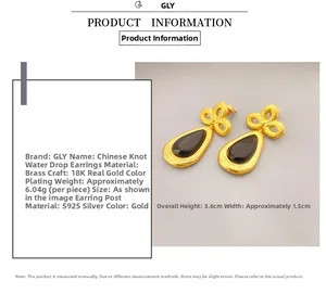 Detail view of gold drop earrings with black stone and 18K plated knot texture