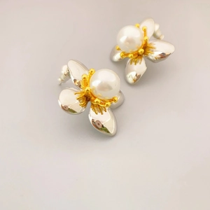 Two-tone flower stud earrings with white pearl center and silver-gold petals