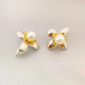 Elegant two-tone flower stud earrings with silver petals and center pearl accents