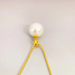 Elegant 18K gold box chain necklace featuring a large round white pearl pendant for women
