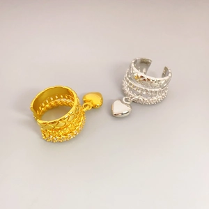 Quilted gold and silver ear cuff set with pavé diamonds and a dangling heart charm