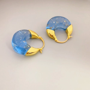 Elegant C-shaped blue resin hoop earrings with gold leaf and metallic hinges