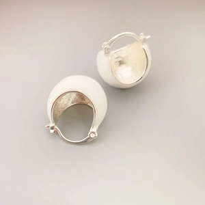 Modern half-dome hoop earrings with white enamel finish and hammered silver texture