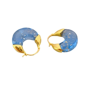Modern C-shaped blue resin hoop earrings with gold foil flakes and golden metal clasps