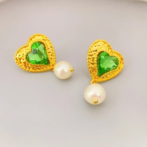 Vintage gold heart earrings with green crystal and pearl pendant on a grey background