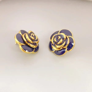 Vintage gold rose stud earrings with deep blue enamel petals for a stylish floral look