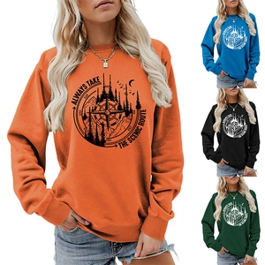 Detail of artistic mountain and forest graphic print with scenic route slogan on sweatshirt
