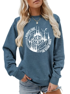 Detail of the blue sweatshirt showing compass and forest print with scenic route text