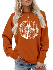 Detail of soft orange crewneck sweatshirt with outdoor adventure compass graphic print