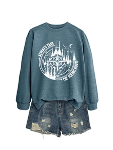 Close-up of Always Take The Scenic Route graphic sweatshirt with distressed denim shorts