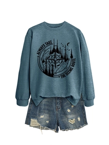 Detailed view of the mountain and forest print on a stylish blue-grey sweatshirt