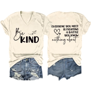 Detail of V-neck T-shirt with Be Kind print and ripped denim shorts summer outfit set