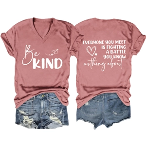 Flat lay of dusty rose V-neck tee with Be KIND print and inspirational text on back