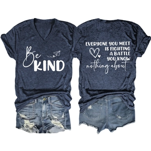 Detail of V-neck T-shirt with 'Be KIND' print and distressed denim shorts set