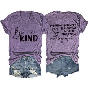 Detail of purple V-neck T-shirt with Be Kind print and distressed denim shorts