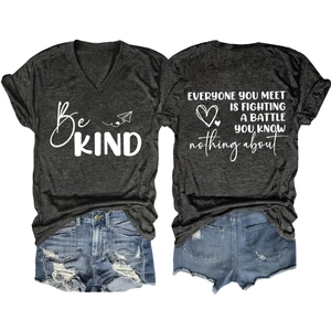 Flat lay of gray V-neck T-shirt with Be KIND print and ripped denim shorts set