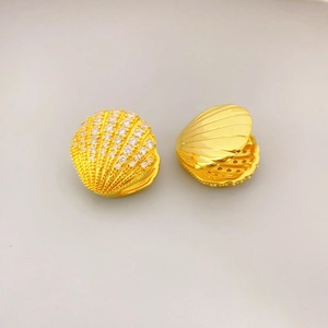 Gold fan-shaped shell earrings with sparkling zircons and detailed metal relief texture