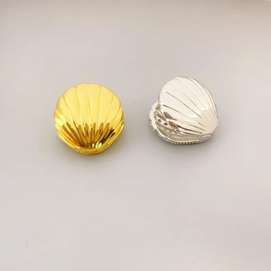 Elegant shell shaped stud earrings with diamond accents in gold and silver finish