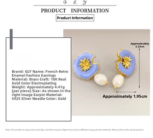 Detail of blue enamel flower earrings with pearly teardrop and 18K gold plated finish