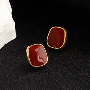 French vintage square burgundy stud earrings with gold trim on black silk background