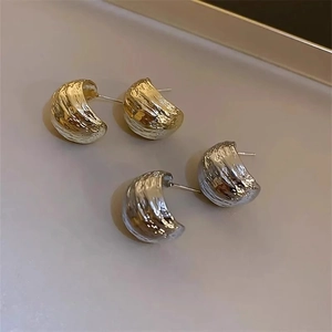 Geometric C-shape earrings with textured molten metal finish in gold and silver