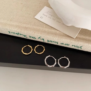 Bamboo style hoop earrings in gold and silver finish with minimalist textured design