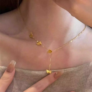 Élégant collier en Y en acier titane doré avec papillons 3D porté par un mannequin