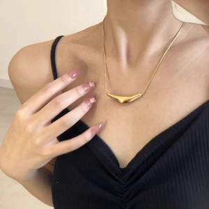 Minimalist 18K gold plated titanium necklace featuring a sleek curved triangular pendant