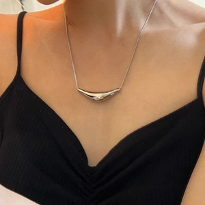 Minimalist silver triangle curved tube necklace on model with 18K gold plated finish
