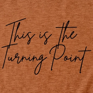Macro detail of the This is the Turning Point print on a brick red cotton t-shirt fabric