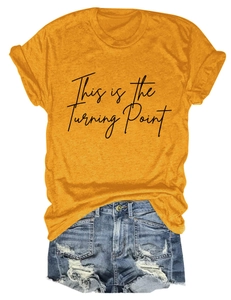 Detail of yellow T-shirt with This is the Turning Point print and denim shorts