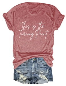Detail view of casual brick red crewneck T-shirt with white letter print and denim shorts