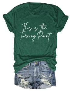 Detail of green T-shirt with 'This is the Turning Point' text and distressed denim shorts