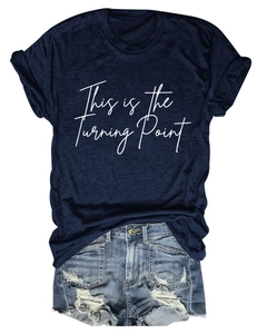 Flat lay of navy blue T-shirt with white script text and distressed denim shorts